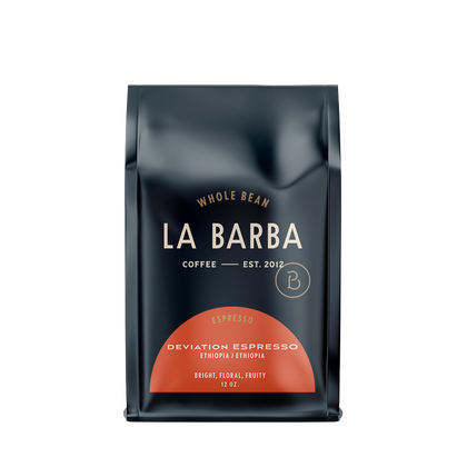 Load image into Gallery viewer, The image features a 12oz bag of La Barba Coffee, specifically their Deviation Espresso. The bag is designed with a dark background, prominently displaying the brand name "La Barba" in large, elegant letters. It highlights the coffee's origin, Ethiopia, along with a description of the flavor profile, including notes of Bright, Floral ,and Fruity. The design exudes a premium and modern feel with a minimalist, sophisticated look.