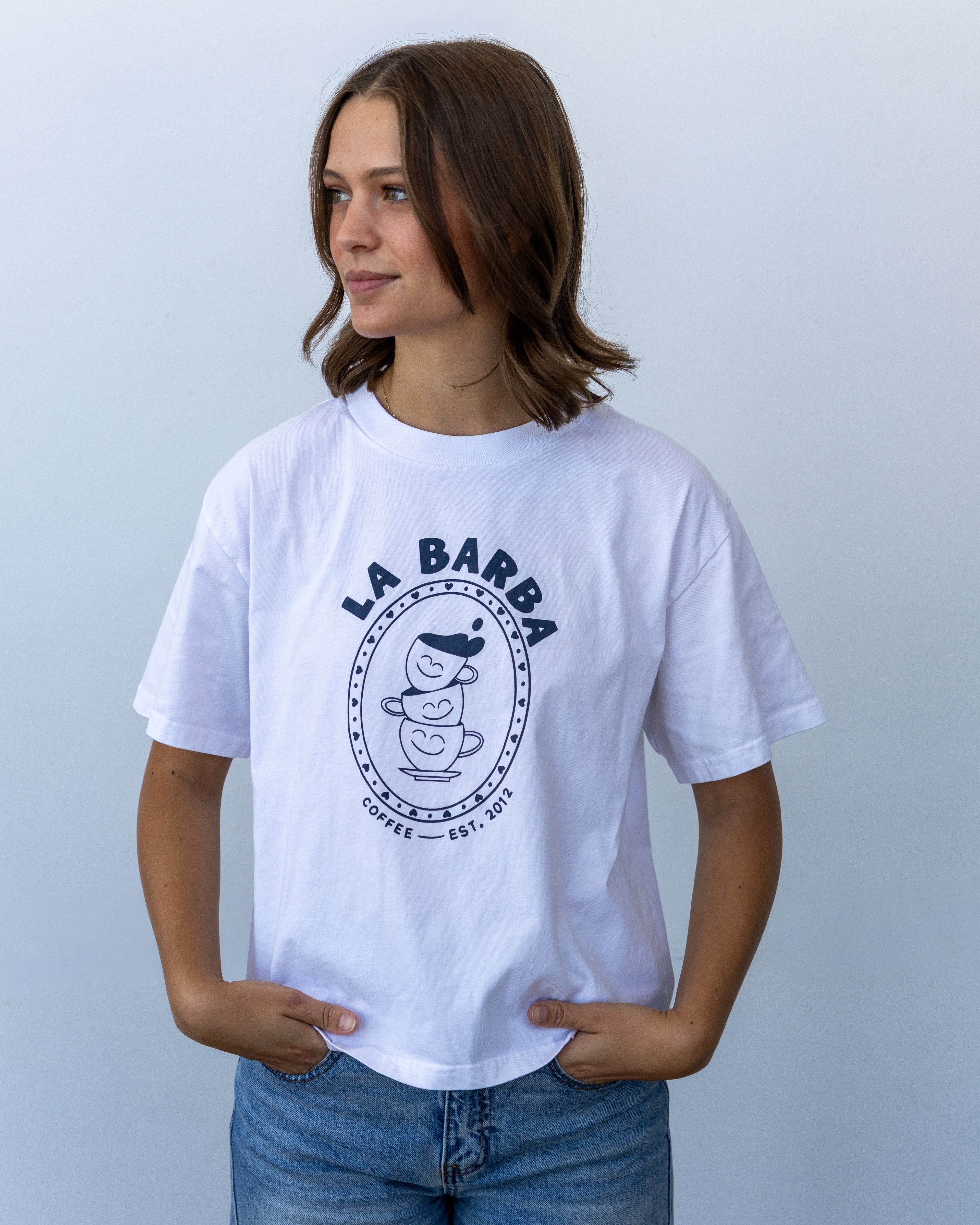 Person wearing a white t-shirt with 'La Barba' logo against a light gray background