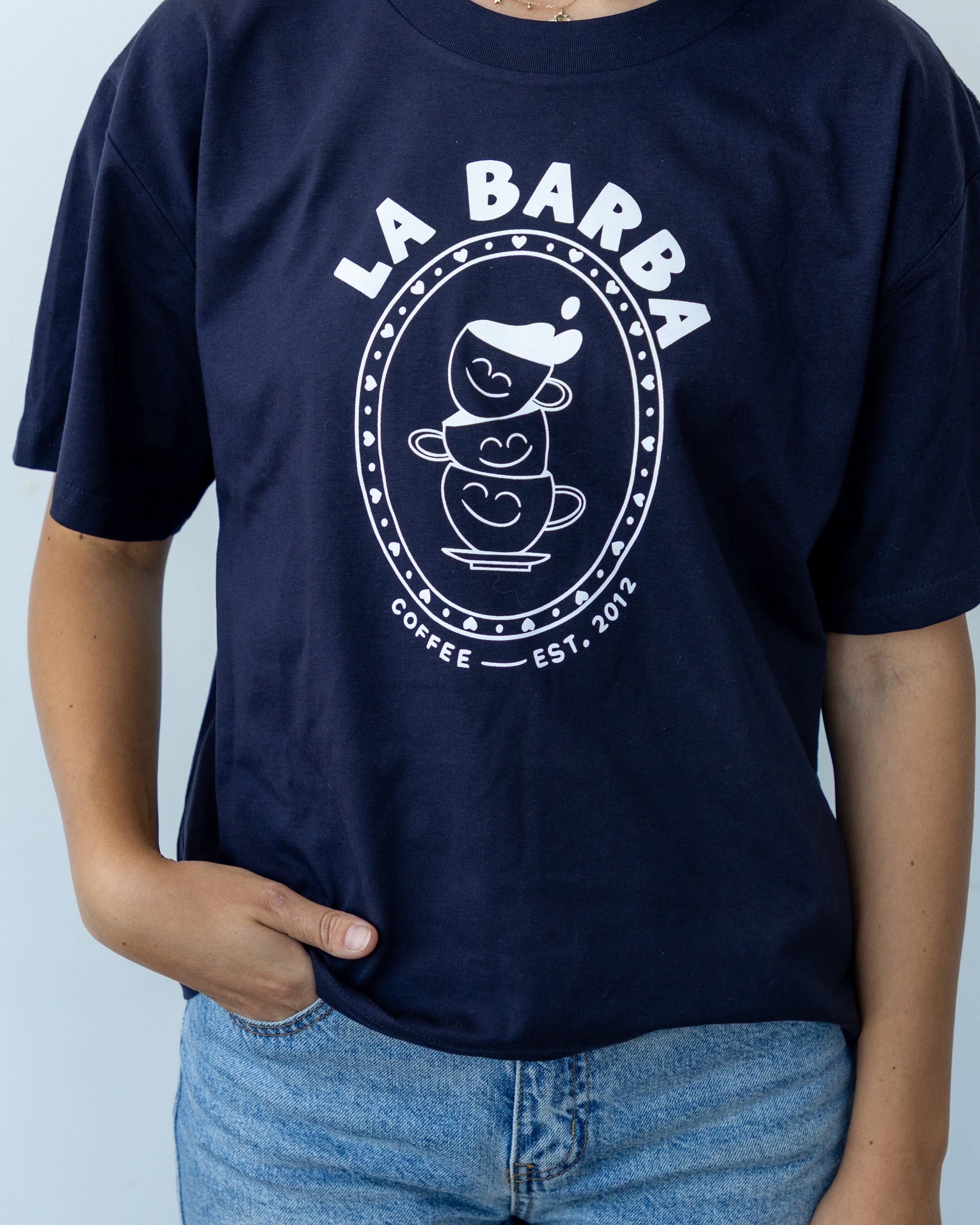 Navy blue t-shirt with 'La Barba Coffee' logo worn by a person against a light gray background