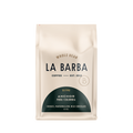 The image features a 12oz bag of La Barba Coffee, specifically their Anchor Blend. The bag is designed with an ivory white background, prominently displaying the brand name "La Barba" in large, elegant letters. It highlights the coffee blend's origins, Peru and Colombia, and includes a description of the flavor profile, including notes of Cookies, Marshmallow, amd Milk Chocolate. The design exudes a premium and modern feel with a minimalist, sophisticated look.