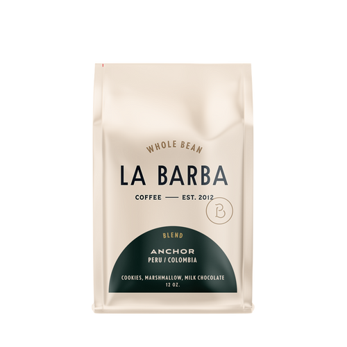 The image features a 12oz bag of La Barba Coffee, specifically their Anchor Blend. The bag is designed with an ivory white background, prominently displaying the brand name "La Barba" in large, elegant letters. It highlights the coffee blend's origins, Peru and Colombia, and includes a description of the flavor profile, including notes of Cookies, Marshmallow, amd Milk Chocolate. The design exudes a premium and modern feel with a minimalist, sophisticated look.