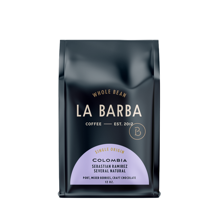 The image features a 12oz bag of La Barba Coffee, specifically their Colombia Sebastian Ramirez Natural single-origin coffee. The bag is designed with a dark background, prominently displaying the brand name 