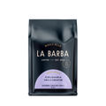 The image features a 12oz bag of La Barba Coffee, specifically their Colombia Finca La Concepcion. The bag is designed with a dark background, prominently displaying the brand name "La Barba" in large, elegant letters. It highlights the coffee's origin, Colombia, along with a description of the flavor profile, including notes of blackberry, cantaloupe, and vanilla. The design exudes a premium and modern feel with a minimalist, sophisticated look.