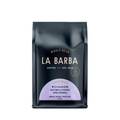 The image features a 12oz bag of La Barba Coffee, specifically their Ecuador Hacienda La Papaya, Sidra Natural. The bag is designed with a dark background, prominently displaying the brand name "La Barba" in large, elegant letters. It highlights the coffee's origin, Ecuador, along with a description of the flavor profile, including notes of apricot, orange, and cream soda. The design exudes a premium and modern feel with a minimalist, sophisticated look.