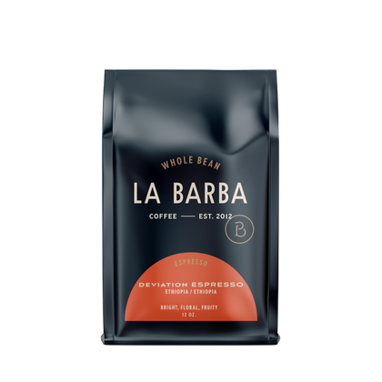 Load image into Gallery viewer, The image features a 12oz bag of La Barba Coffee, specifically their Deviation Espresso. The bag is designed with a dark background, prominently displaying the brand name "La Barba" in large, elegant letters. It highlights the coffee's origin, Ethiopia, along with a description of the flavor profile, including notes of Bright, Floral ,and Fruity. The design exudes a premium and modern feel with a minimalist, sophisticated look.
