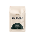 The image features a 12oz bag of La Barba Coffee, specifically their House Blend. The bag is designed with an ivory white background, prominently displaying the brand name "La Barba" in large, elegant letters. It highlights the coffee blend's origins, Peru and Colombia, and includes a description of the flavor profile, including notes of Milk Chocolate, Toffee, and Stone Fruit. The design exudes a premium and modern feel with a minimalist, sophisticated look.