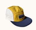 A La Barba branded cap with yellow and white colors and mesh side panels.