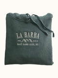 A green hooded sweatshirt with 'La Barba' branding and the text 'Salt Lake City, UT' along with a mountain range illustration.