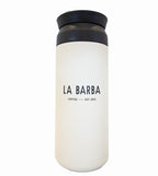 A white Kinto travel tumbler with a black lid and handle, and the brand 'La Barba Coffee' printed on the side.