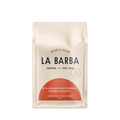 The image features a 12oz bag of La Barba Coffee, specifically their Standard Espresso Blend. The bag is designed with an ivory white background, prominently displaying the brand name "La Barba" in large, elegant letters. It highlights the coffee blend's origins, Colombia and Guatemala, and includes a description of the flavor profile, including notes of Cherry, Maple Syrup, and Almond. The design exudes a premium and modern feel with a minimalist, sophisticated look.