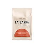 The image features a 12oz bag of La Barba Coffee, specifically their Standard Espresso Blend. The bag is designed with an ivory white background, prominently displaying the brand name "La Barba" in large, elegant letters. It highlights the coffee blend's origins, Colombia and Guatemala, and includes a description of the flavor profile, including notes of Cherry, Maple Syrup, and Almond. The design exudes a premium and modern feel with a minimalist, sophisticated look.