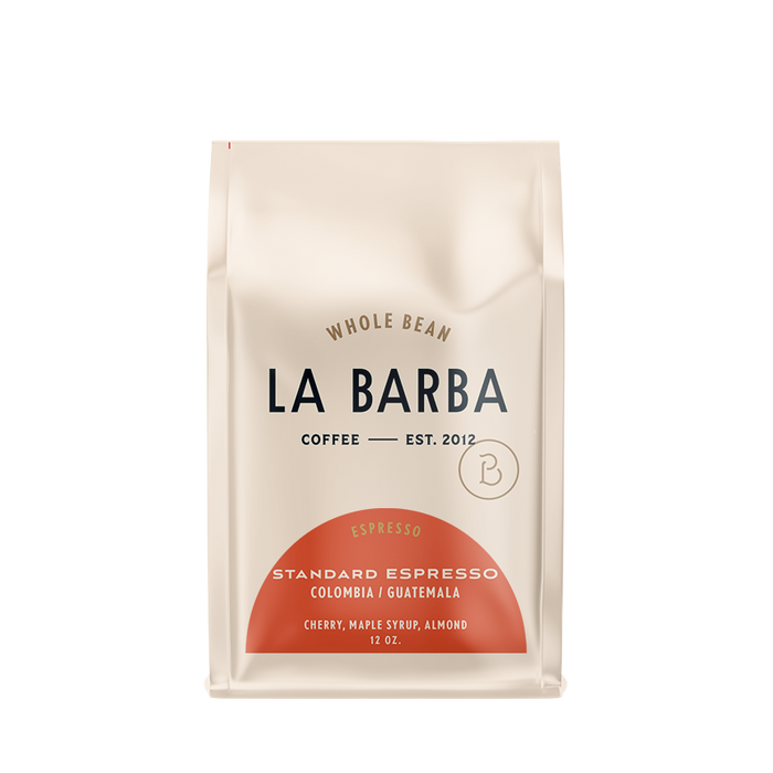 The image features a 12oz bag of La Barba Coffee, specifically their Standard Espresso Blend. The bag is designed with an ivory white background, prominently displaying the brand name 