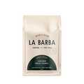 The image features a 12oz bag of La Barba Coffee, specifically their House Blend. The bag is designed with an ivory white background, prominently displaying the brand name "La Barba" in large, elegant letters. It highlights the coffee blend's origins, Mexico and Colombia, and includes a description of the flavor profile, including notes of Milk Chocolate, Toffee, and Stone Fruit. The design exudes a premium and modern feel with a minimalist, sophisticated look.