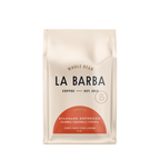 A 12 oz bag of La Barba Whole Bean Coffee, Standard Espresso, in a cream-colored stand-up pouch with a terracotta-colored semi-circle graphic at the bottom and black text.